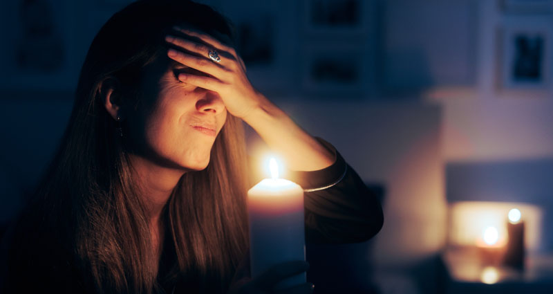 Woman holding candle in the dark