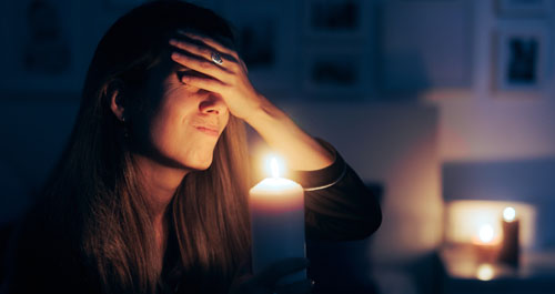 Woman holding candle in the dark