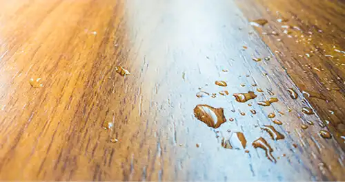 Water spill on wood floor from air conditioner in the house