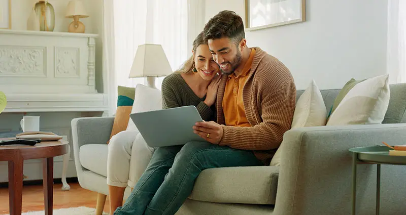 couple reviewing documents on a laptop