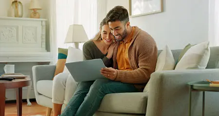 couple reviewing documents on a laptop