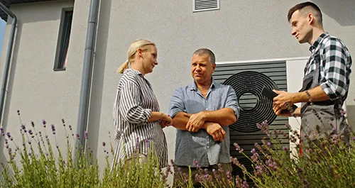 Technician talking to homeowners
