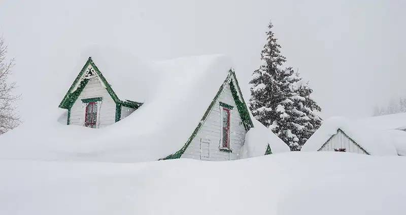 Snow covered home in a snowstorm.