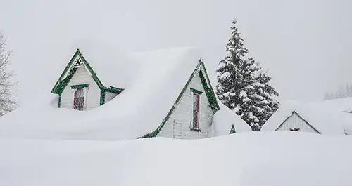 Snow covered home in a snowstorm.
