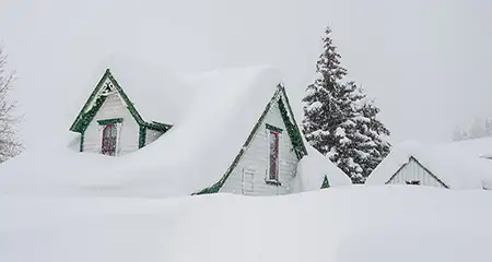 Snow covered home in a snowstorm.