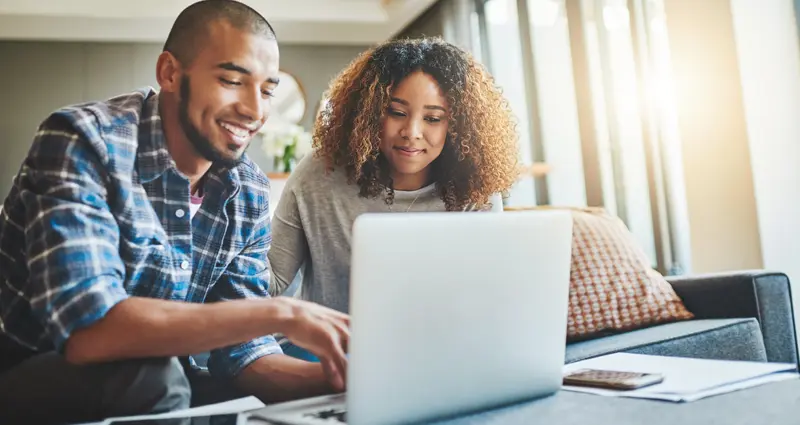Couple searching on laptop