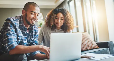 Couple searching on laptop