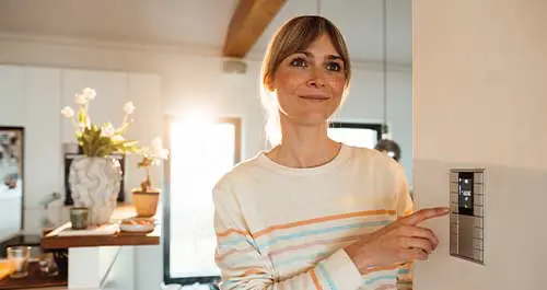 Woman checking settings on the furnace