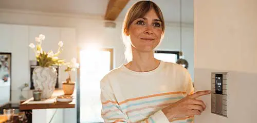 Woman checking settings on the furnace