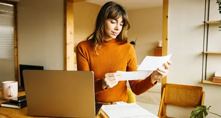 Woman reading her utility bill