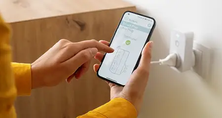 Homeowner adding smart plug to smart home