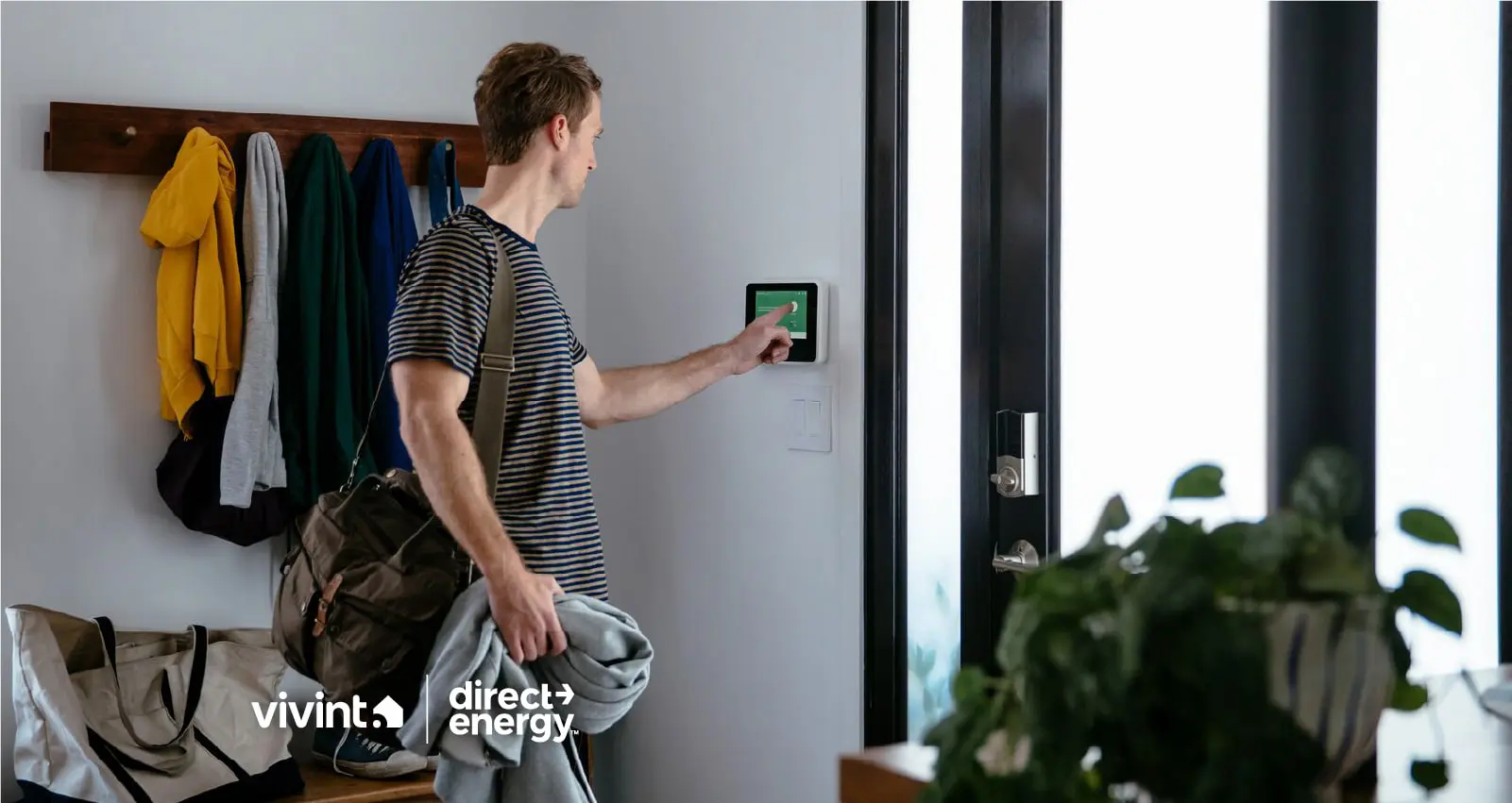Man setting smart thermostat