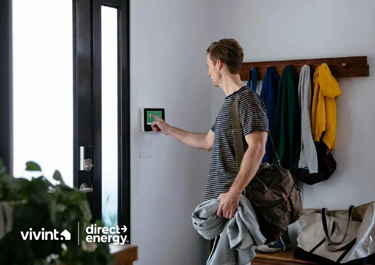 Man setting smart thermostat