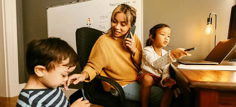 Work at home mom at desk with daughter and son