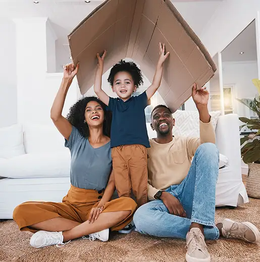 family having fun while moving making a cardboard house