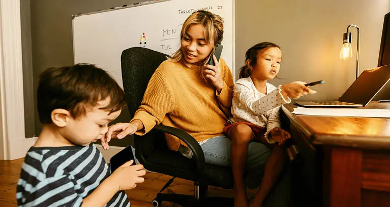 Work at home mom at desk with daughter and son