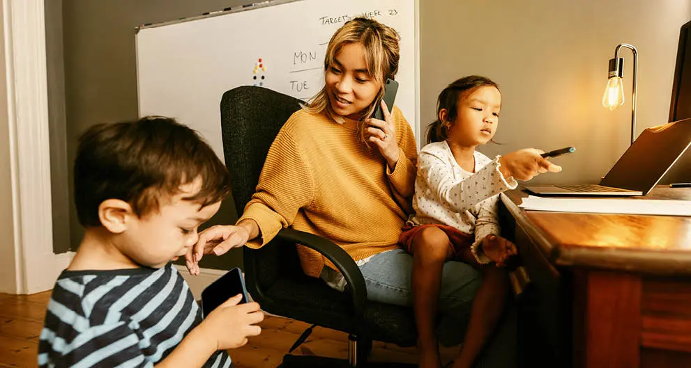 Work at home mom at desk with daughter and son
