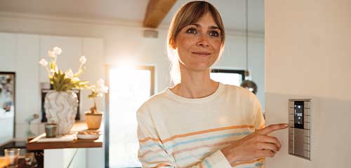 woman adjusting smart home panel