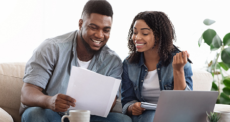 Couple bill budgeting at home on the couch