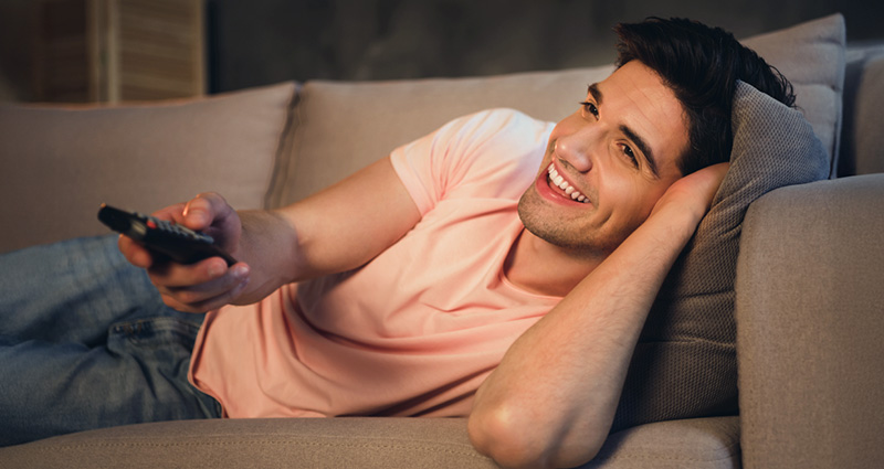 guy watching tv on sofa