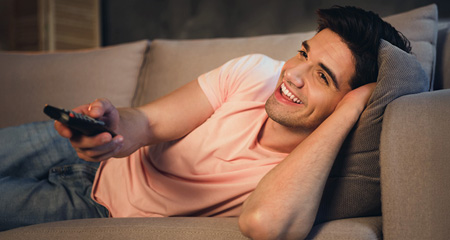 guy watching tv on sofa