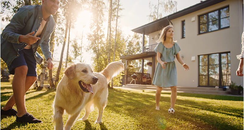 Family and friends enjoying an evening eating dinner in the backyard 