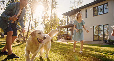 Family and friends enjoying an evening eating dinner in the backyard 