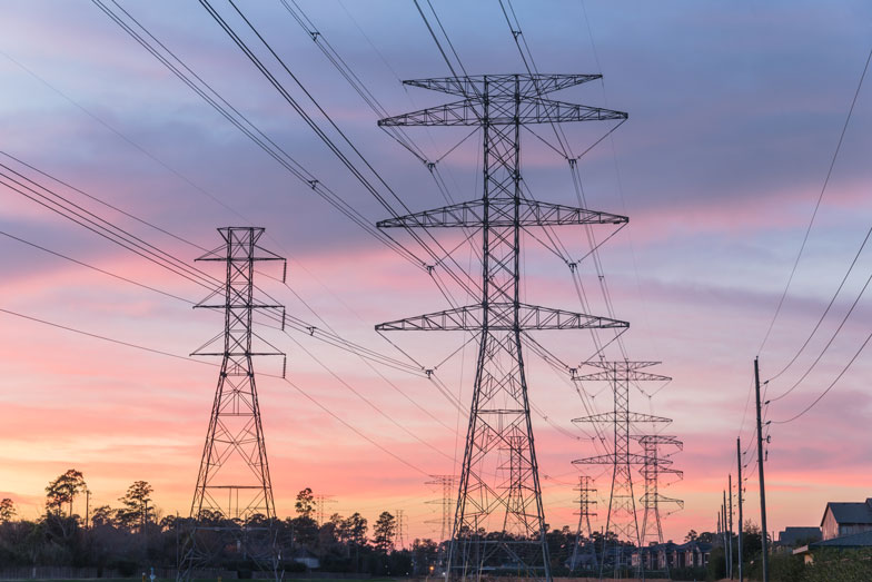 Photo of residential electricity powerline grid during sunset