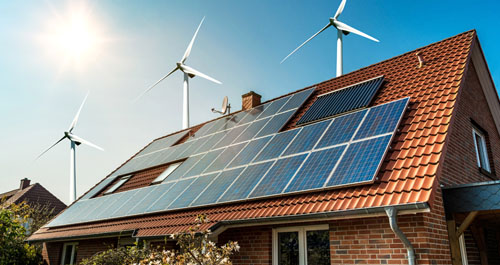 Image of a home with solar panels and wind turbines