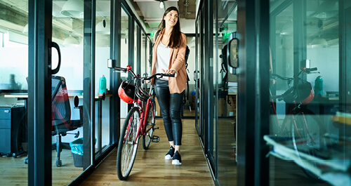 Businesswoman arriving to work on bike