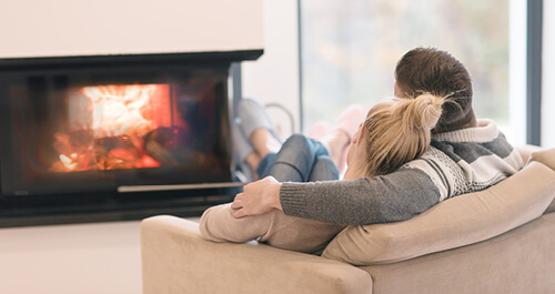 Young couple in front of fireplace