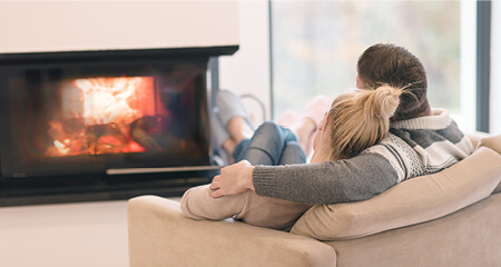 Young couple in front of fireplace