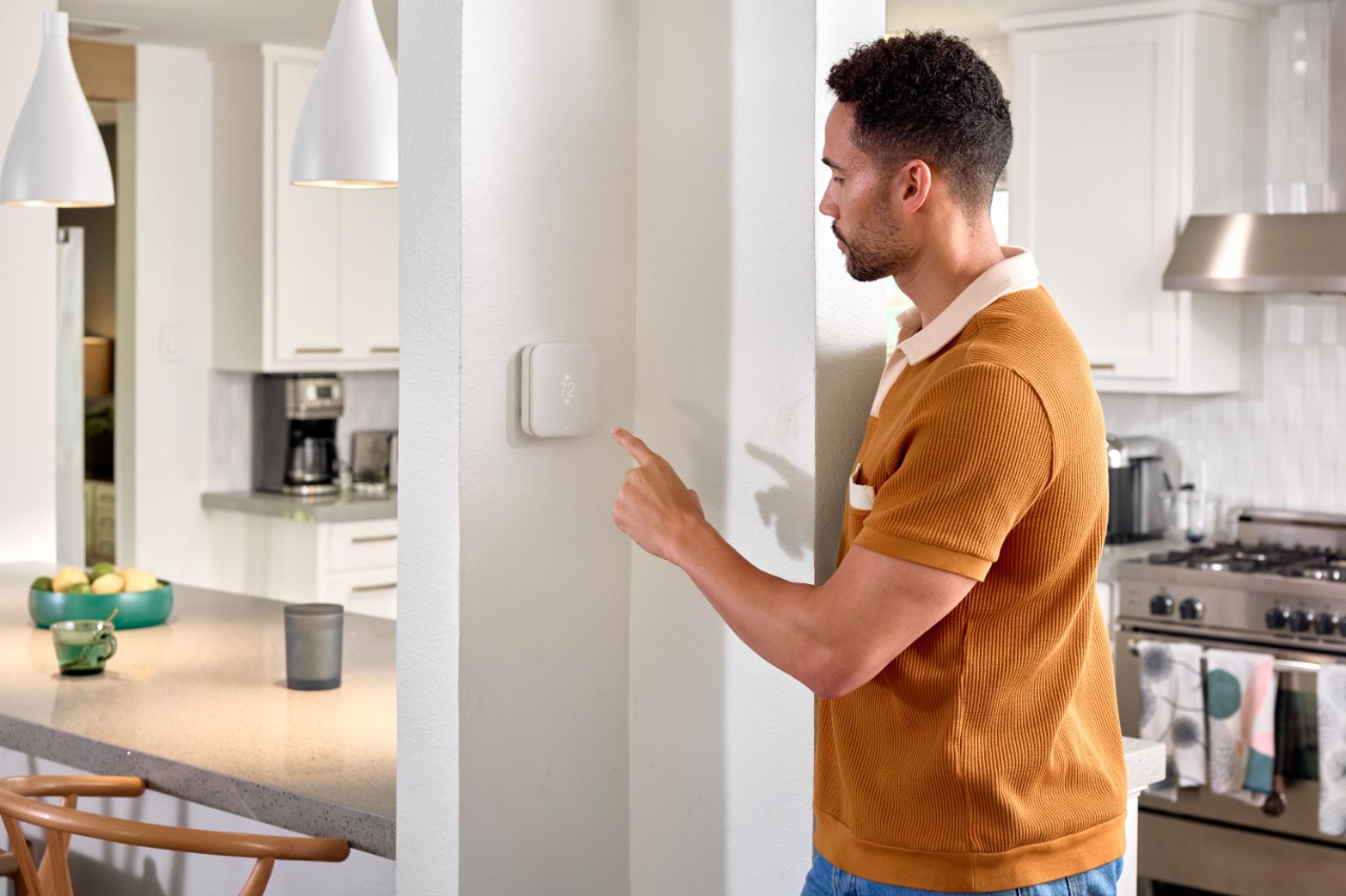 Photo of a smart thermostat on a wall inside a home