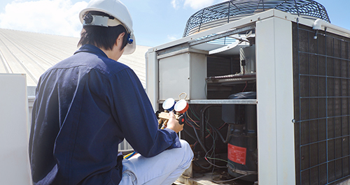 Photo of someone making repairs to their HVAC system