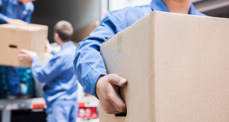 Movers unloading a moving van