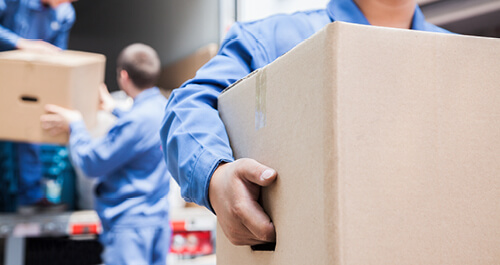 Movers unloading a moving van