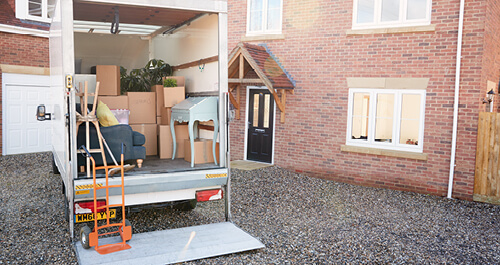 Moving van loaded and parked outside home