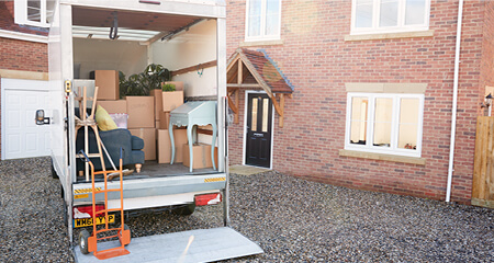 Moving van loaded and parked outside home