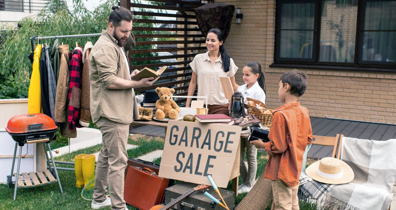 Family selling at garage sale to customer