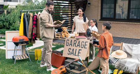 Family selling at garage sale to customer