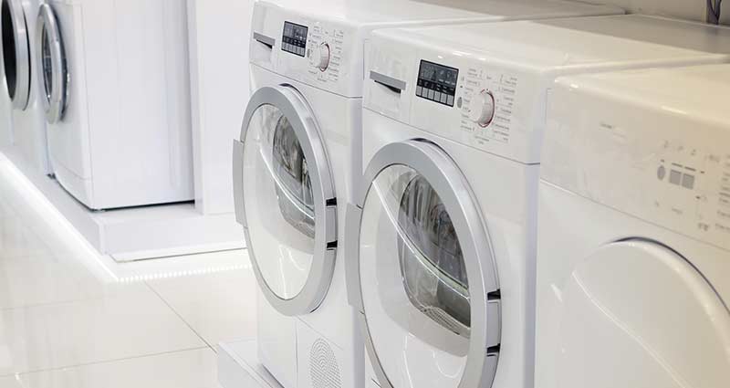 Lots of laundry appliances in a row