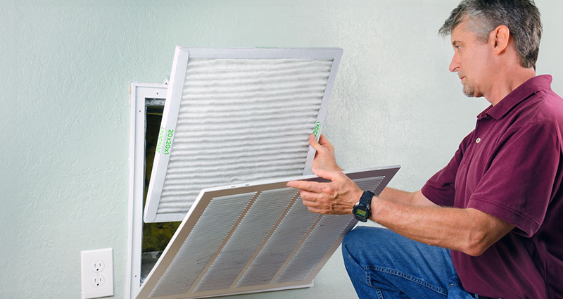 Man changing AC filter(