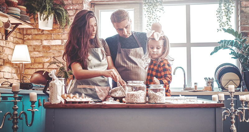 Happy family cooking together at kitchen counter
