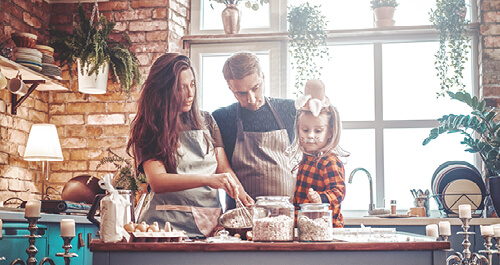 Happy family cooking together at kitchen counter