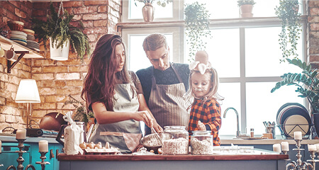 Happy family cooking together at kitchen counter