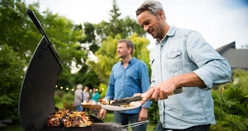 People grilling in the backyard in summer