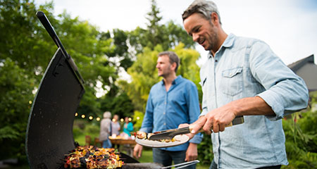 People grilling in the backyard in summer