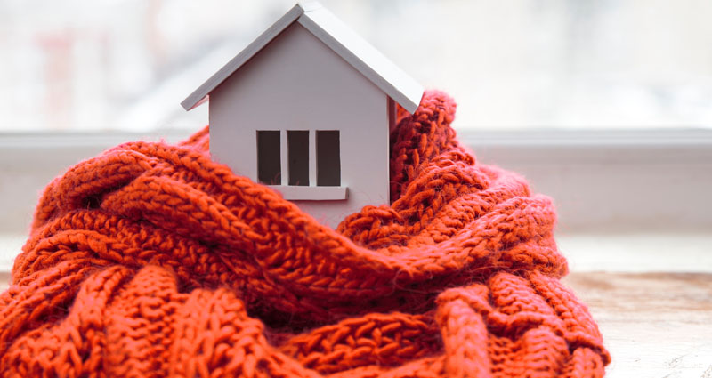 Toy house wrapped in comfy scarf