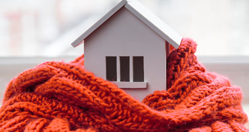 Toy house wrapped in comfy scarf