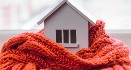 Toy house wrapped in comfy scarf